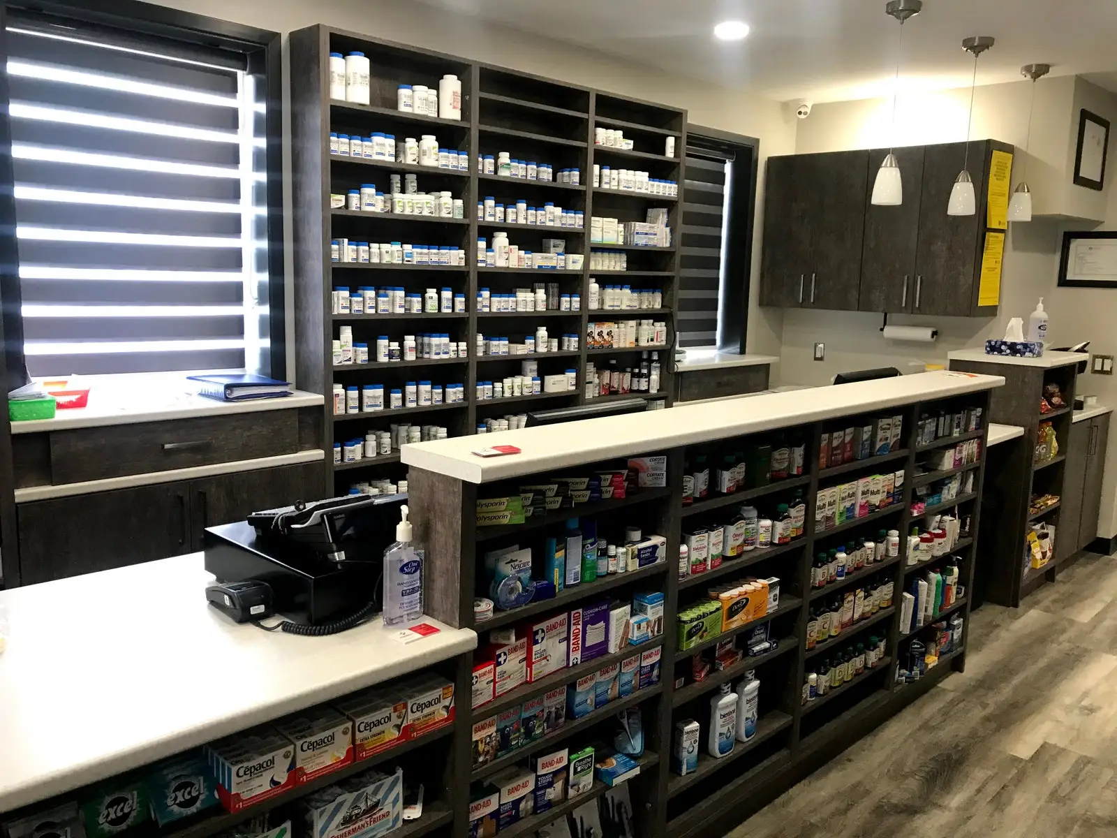 Pharmacy counter with shelves of medications behind it
