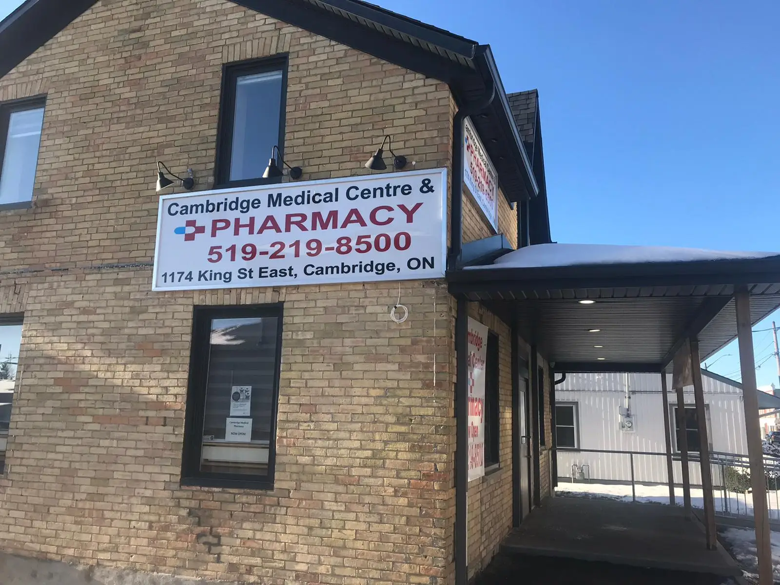 Side of the building with a sign reading Cambridge Medical Centre and Pharmacy, 519-219-8500